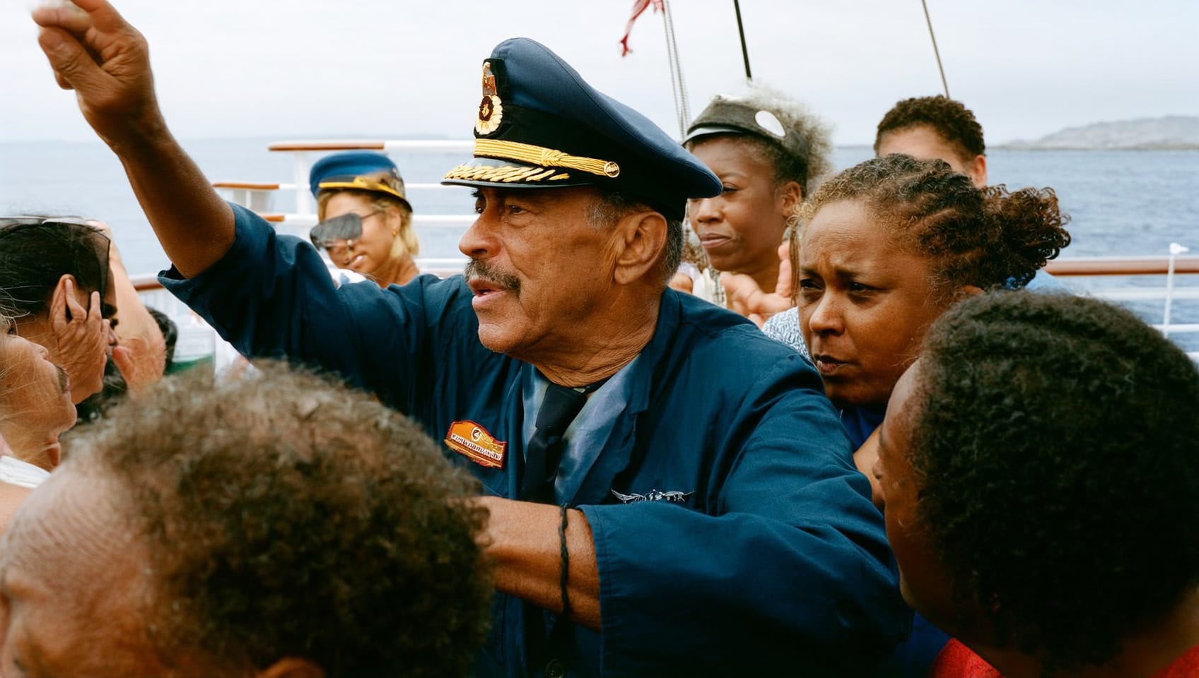 A veteran captain at the helm sharing a laugh with guests aboard a charter cruise